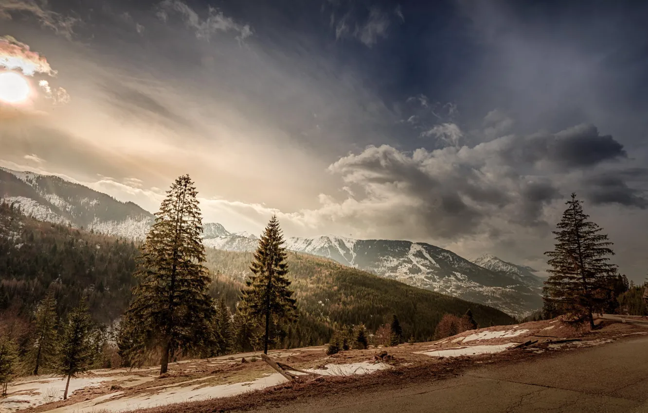 Photo wallpaper road, the sky, the sun, clouds, snow, trees, landscape, mountains