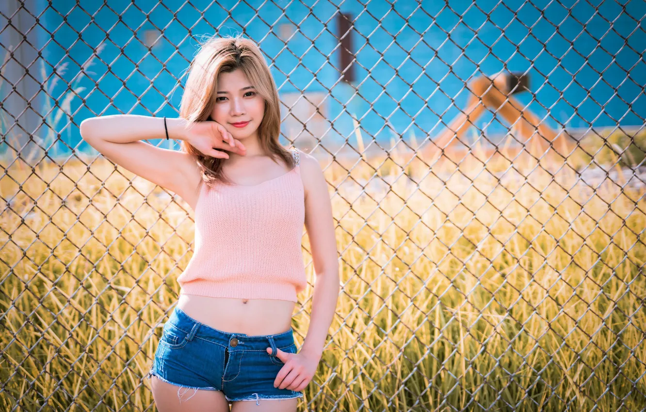 Photo wallpaper grass, look, the sun, pose, model, the fence, shorts, portrait