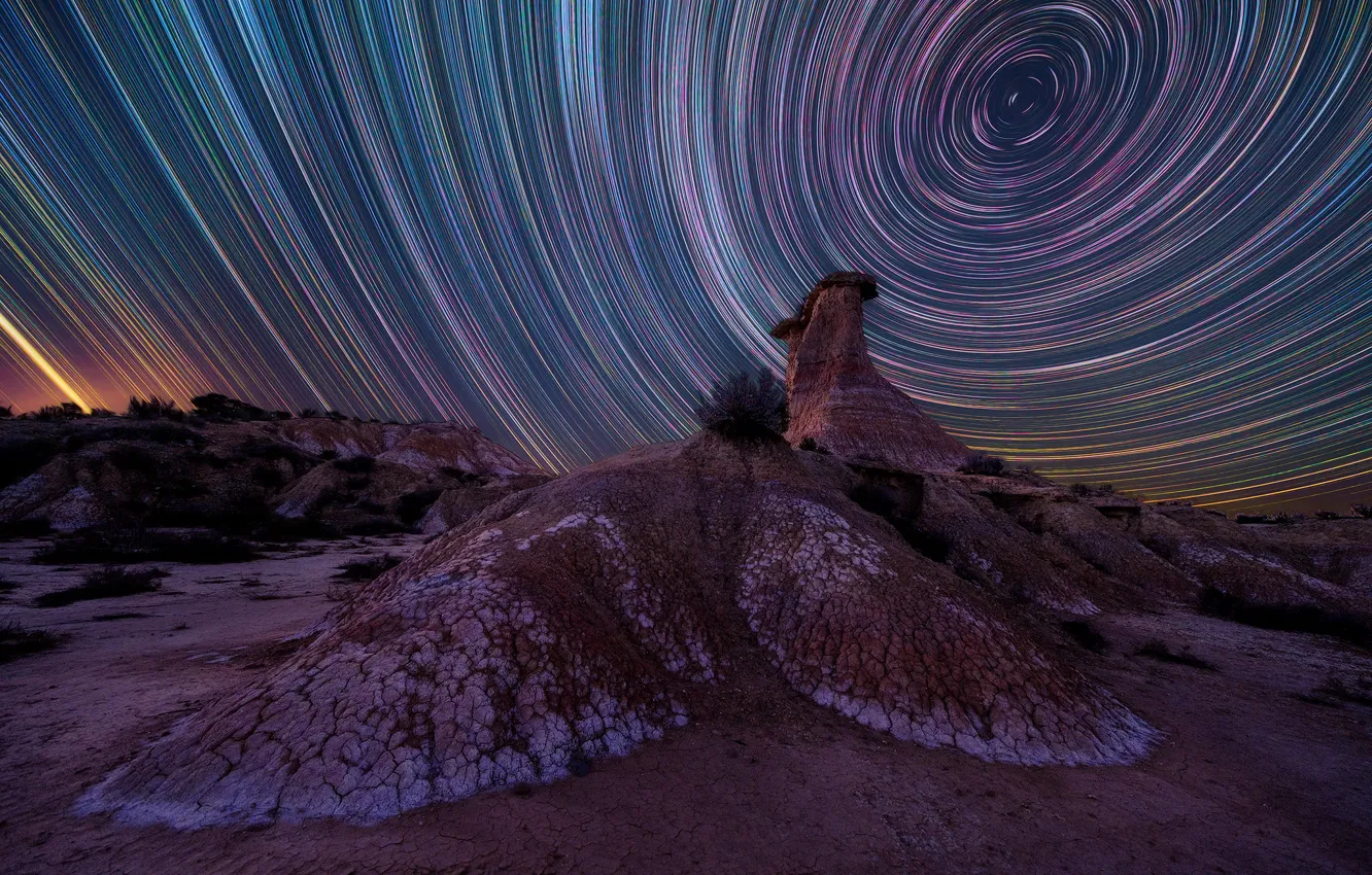 Photo wallpaper the sky, space, stones, rocks, hills, desert, rotation, star tracks