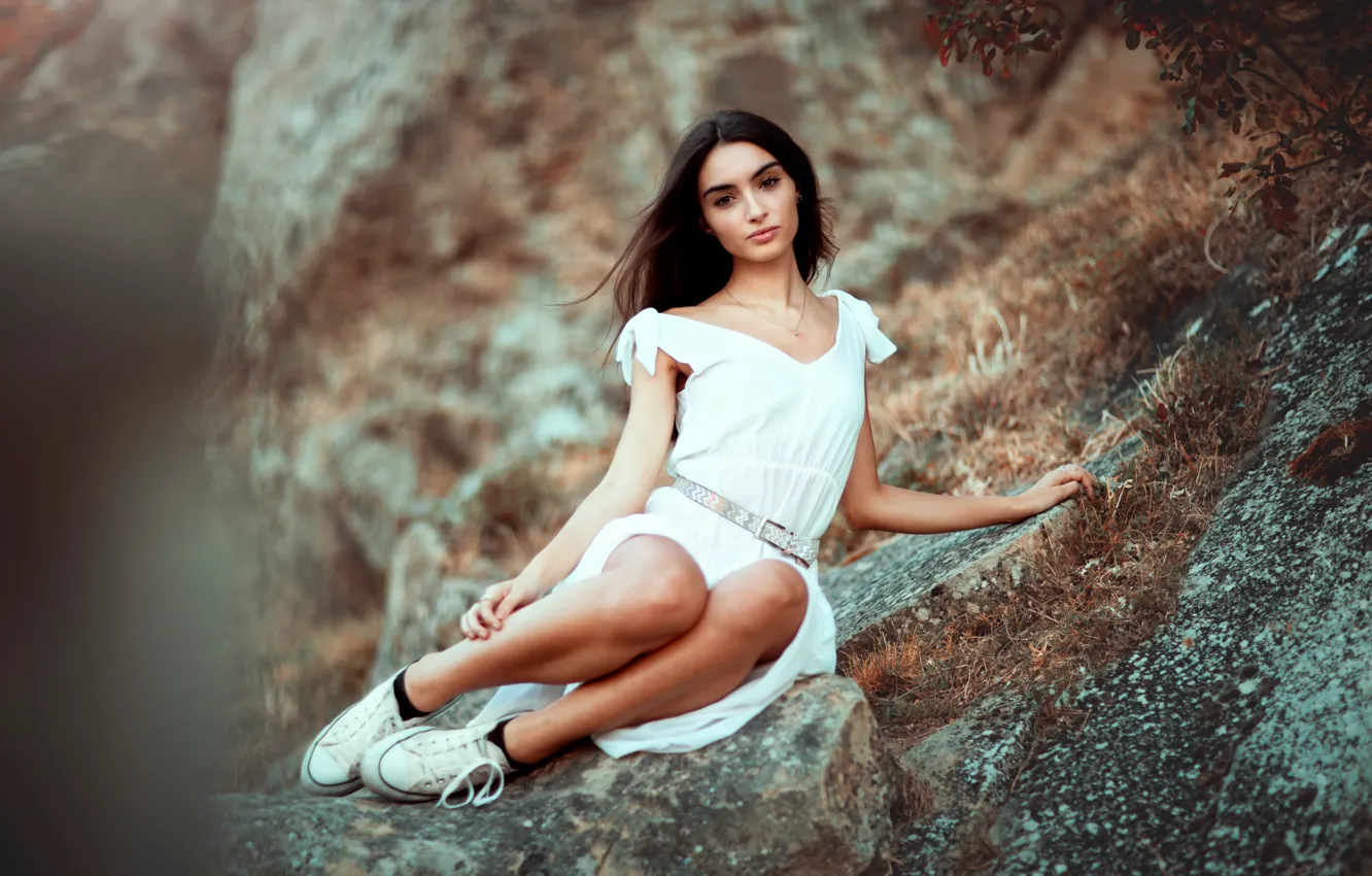 Photo wallpaper grass, look, girl, mountains, nature, pose, stones, rocks