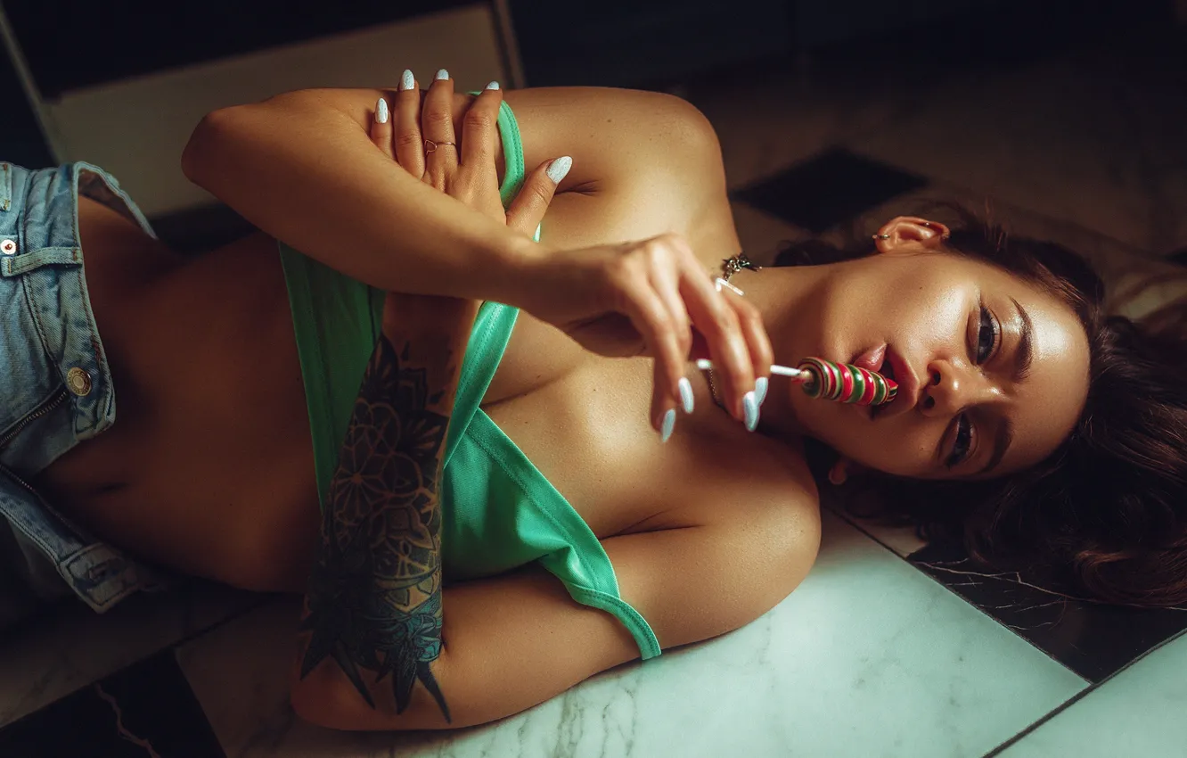 Photo wallpaper girl, pose, jeans, hands, tattoo, candy, lollipops, top