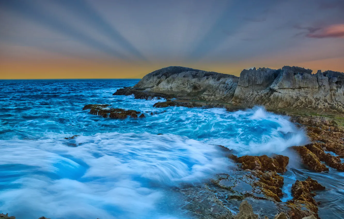 Photo wallpaper sea, wave, the sky, clouds, rays, sunset, stones, rocks