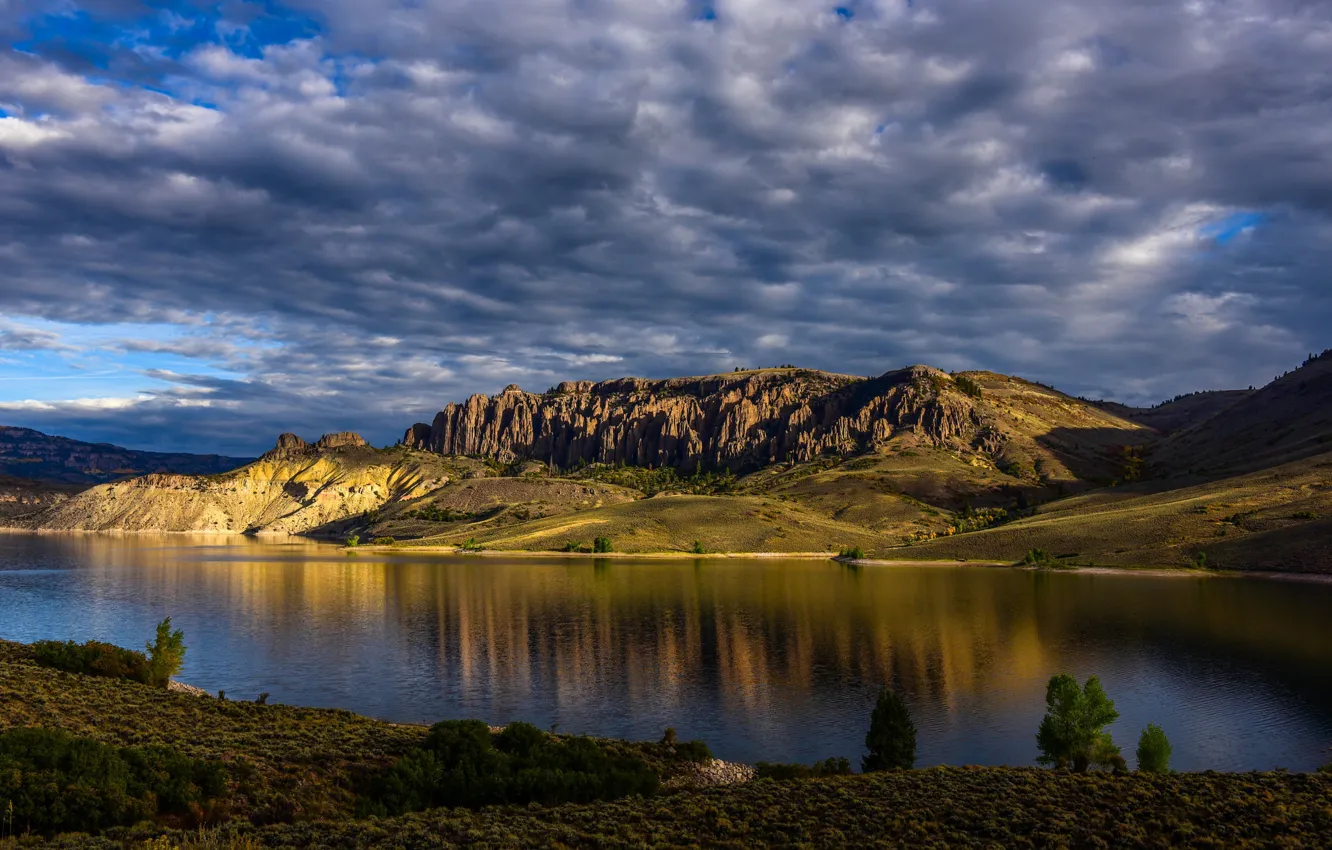 Photo wallpaper the sky, clouds, light, mountains, blue, rocks, shore, slope