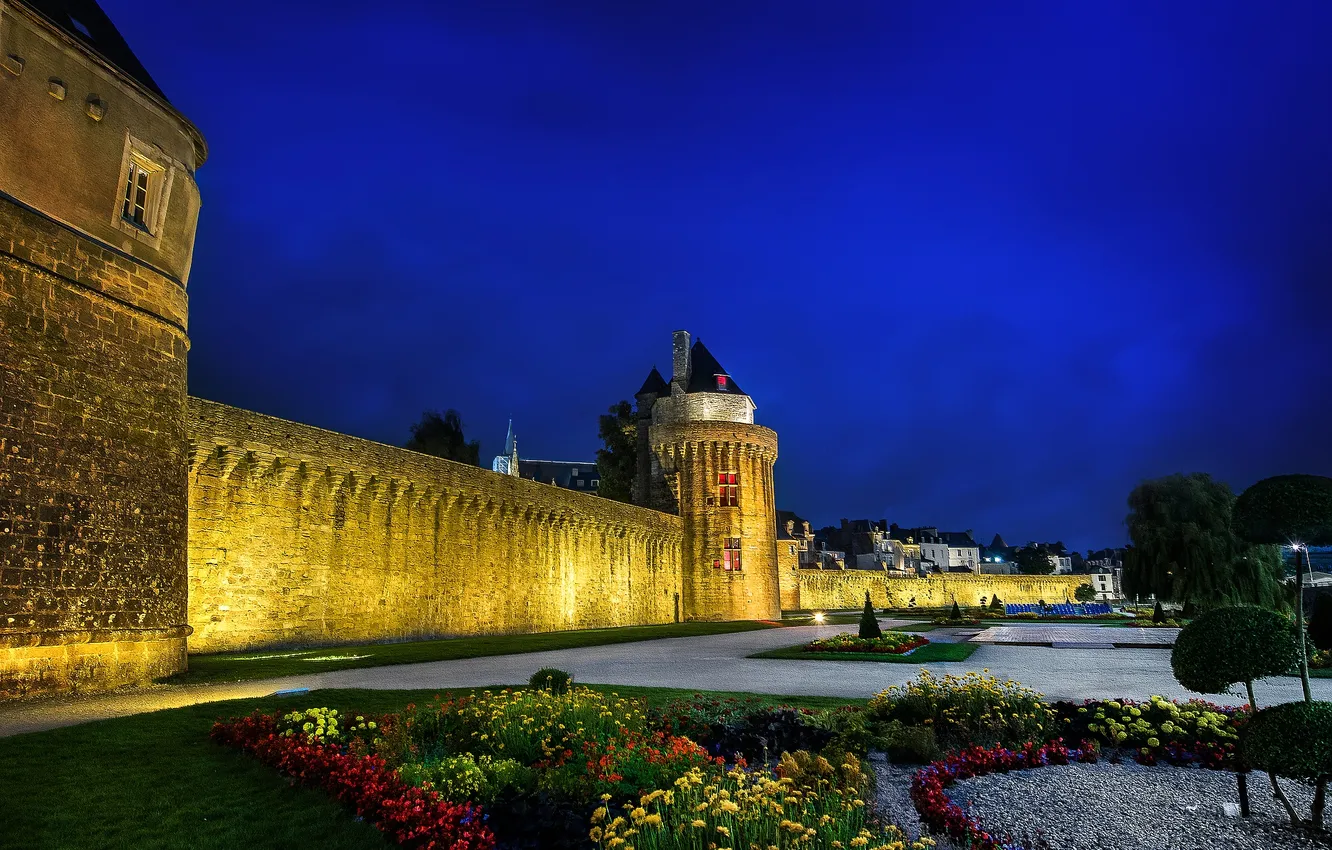 Photo wallpaper trees, flowers, night, lights, castle, wall, tower, flowerbed